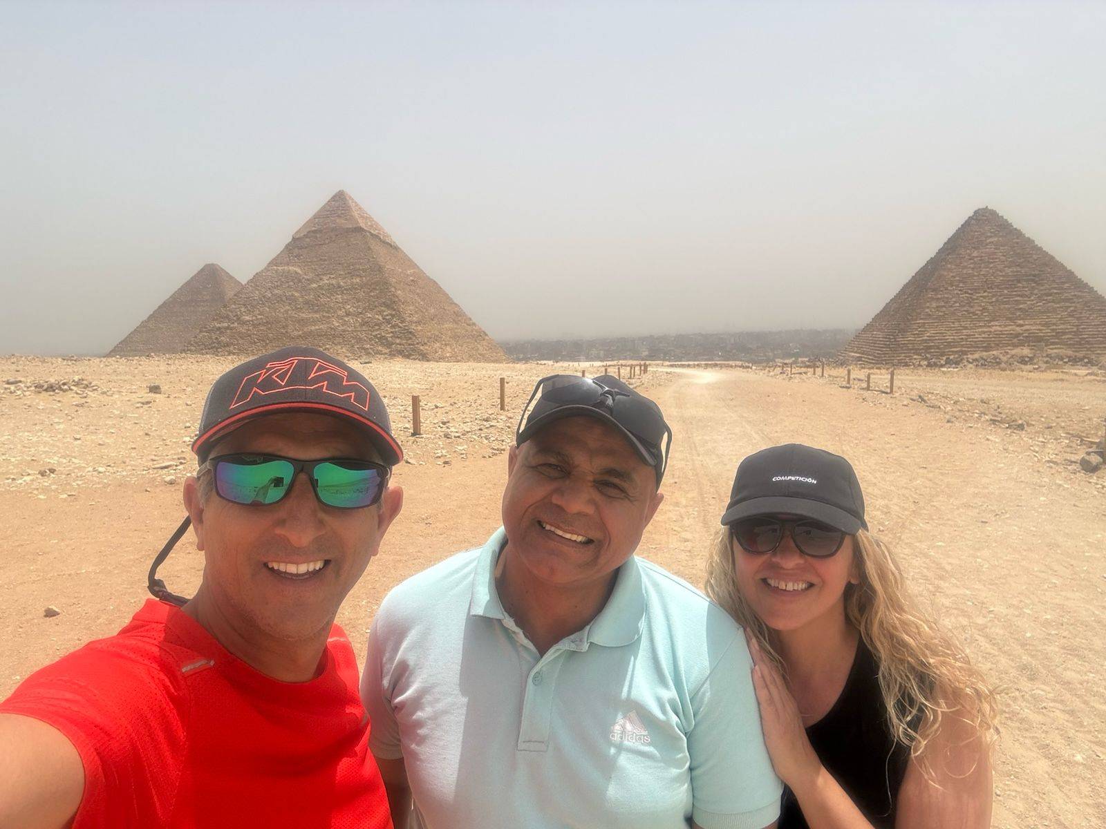 Travelers taking photos at the Giza Plateau during a guided tour